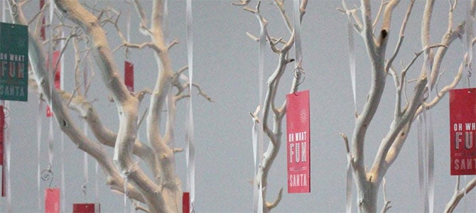 A small decorative tree holds Sub for Santa tags which contain a child’s name.